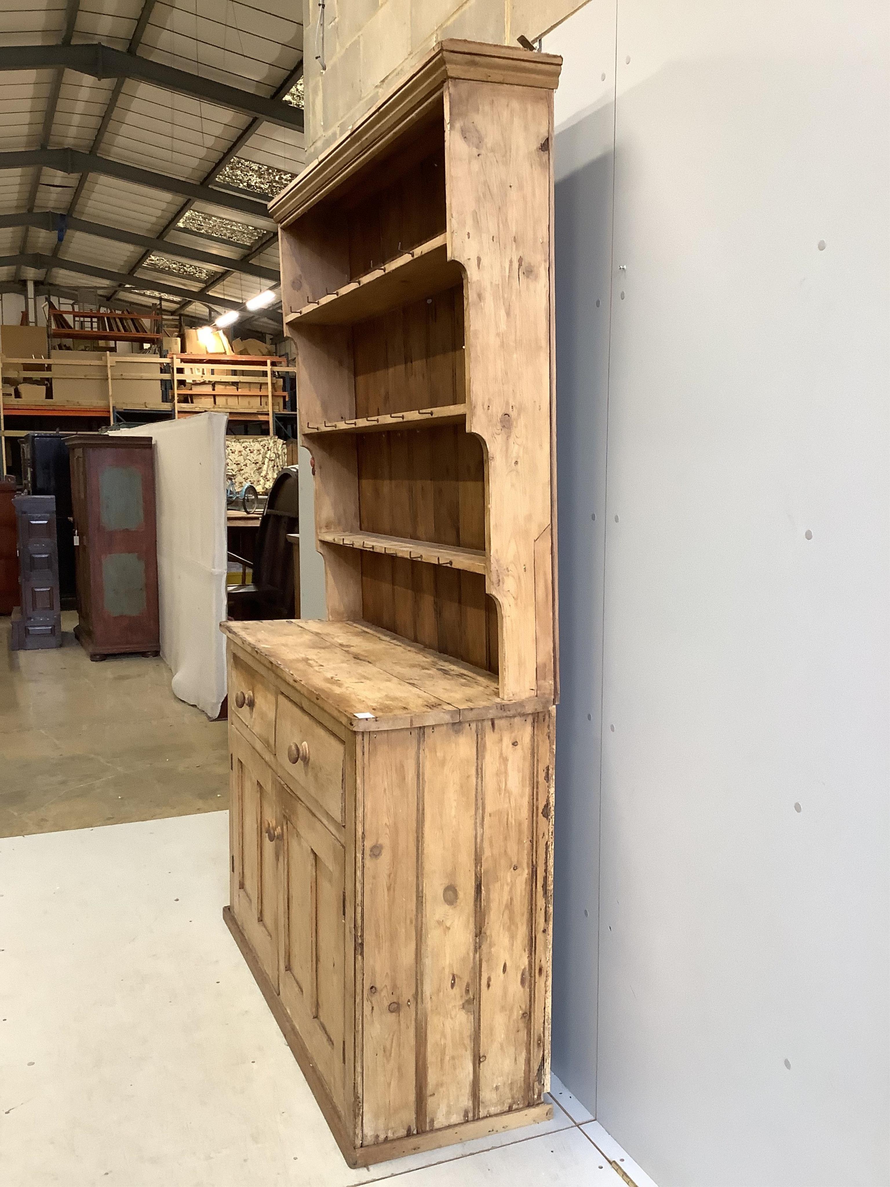 A Victorian pine dresser with boarded rack, width 140cm, depth 46cm, height 223cm. Condition - poor